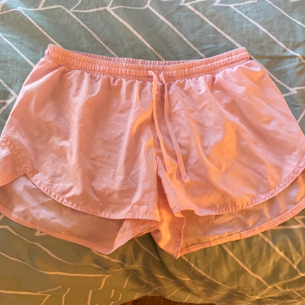 Light pink athletic running shorts.